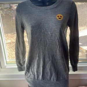 A gray crewneck J.Crew emoji sweater